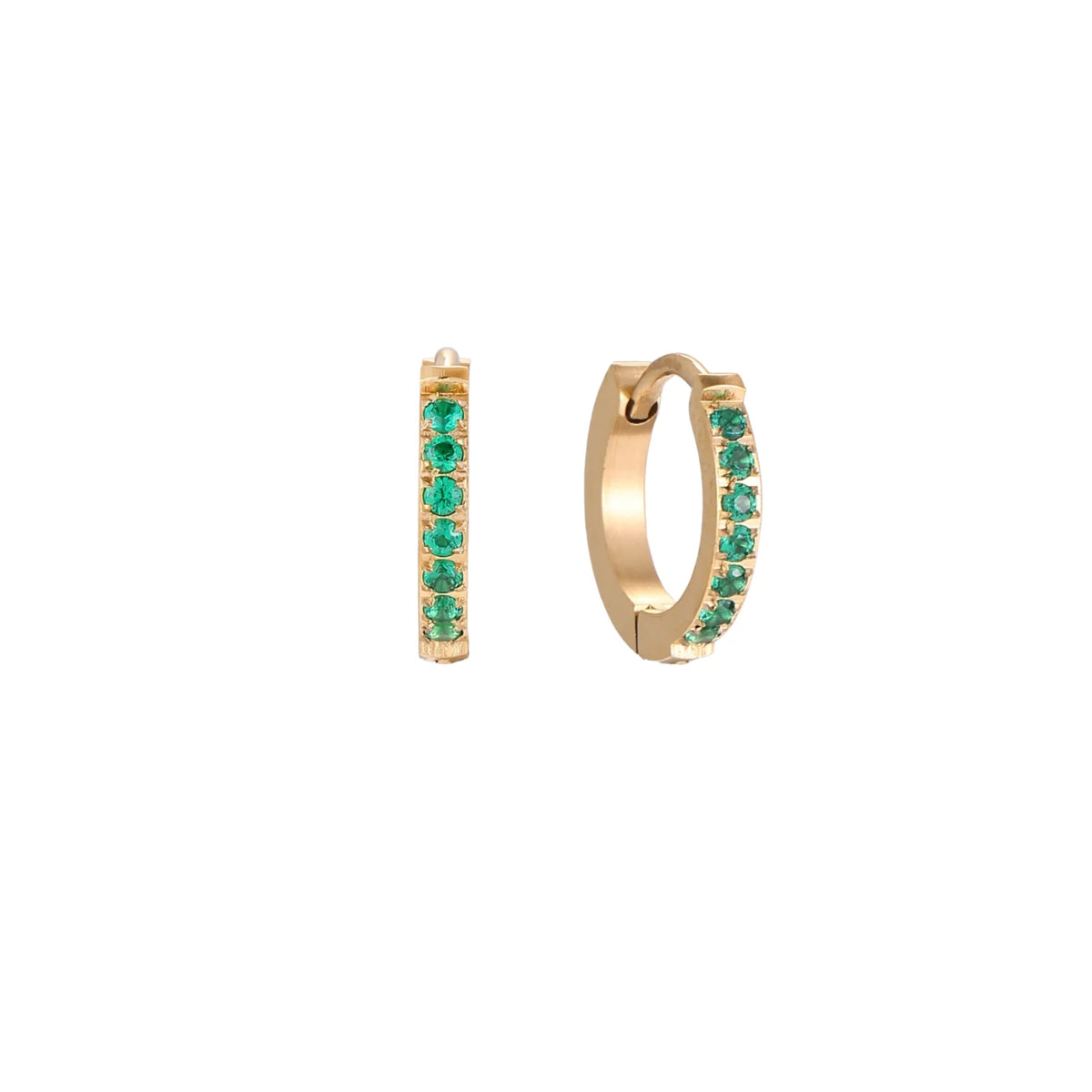 Pair of small gold huggie hoop earrings with bright green cubic zirconia stones on cream background