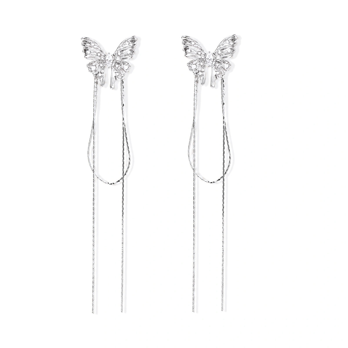 Pair of silver threader earrings with crystal butterfly tops and long chain drops on cream background.