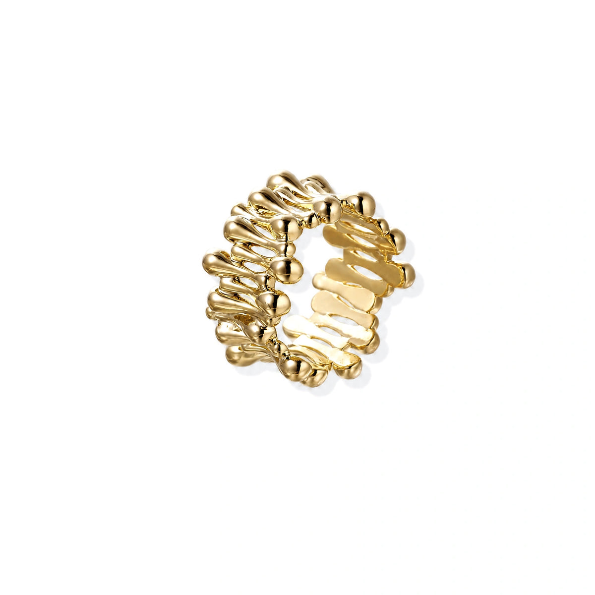 Gold-plated brass ring with sculptural petal-like elements in a wide band design on beige background
