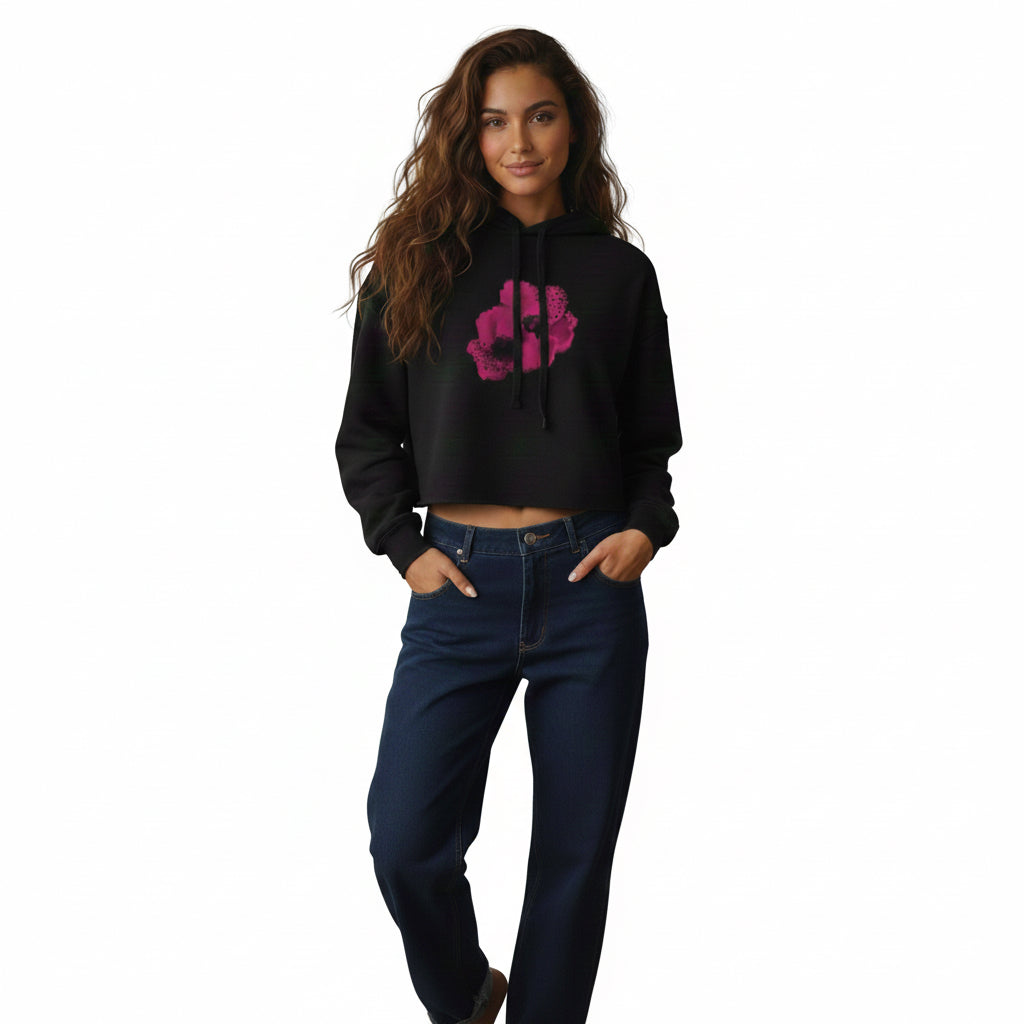 Woman modeling a black hoodie with a pink floral design and blue jeans on a white background