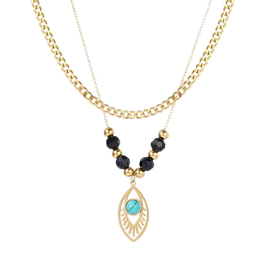 Layered gold necklace with turquoise evil eye pendant and black quartz beads on cream background