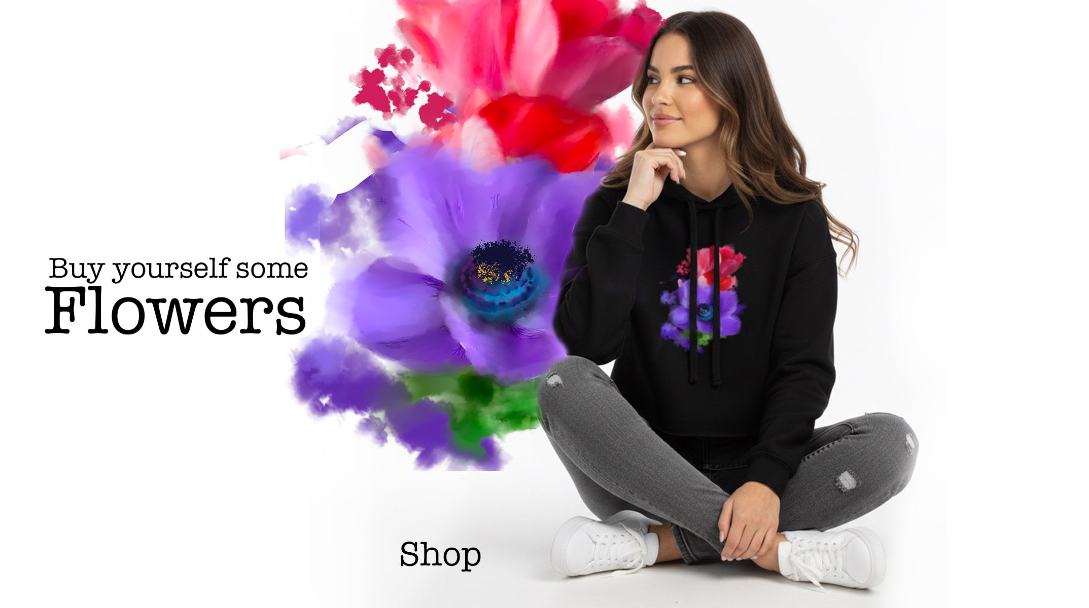 Woman sitting on the floor with a black hoodie featuring colorful floral designs, surrounded by stylized flowers.